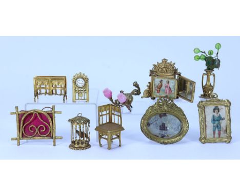 A good selection of gilt metal Dolls House furniture and ornaments, German 19th century, including ornate hanging birdcage wi