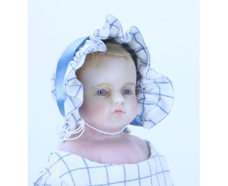 A Pierotti poured wax shoulder head doll, English circa 1860, with inserted light blue glass eyes, painted mouth and remains 