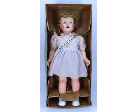 A large hard plastic ‘Winnie She walks! She talks!‘ doll in original box, 1950s, with sleeping green eyes, open mouth, teeth 