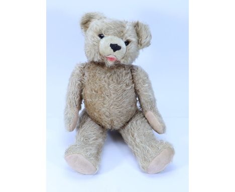 A Hermann Teddy bear, German 1950s, the light brown bear with orange glass eyes, black stitched nose and open felt lined mout