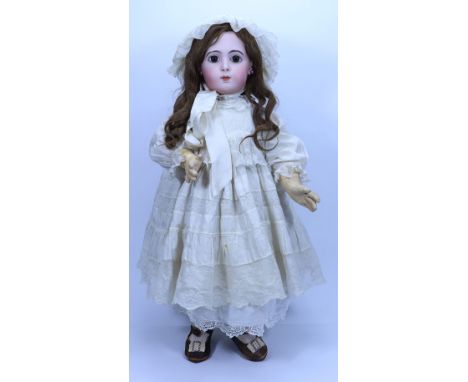 A beautiful and rare Jumeau Triste bisque head Bebe doll, size 13, French circa 1882, the pale bisque head with large brown g