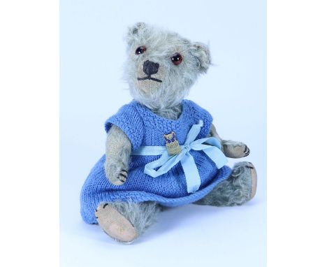 A charming small Chiltern blue mohair Teddy bear, 1920s, with red glass eyes, black stitched nose and mouth, swivel head and 