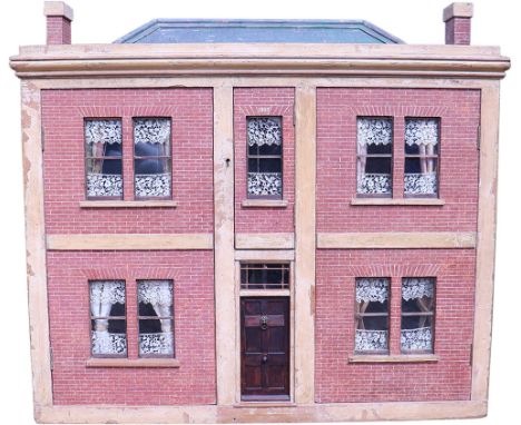 A large and impressive early English Georgian dolls house, 1803, with stained wood and painted red brick façade, hinged and p