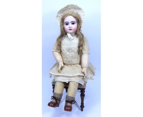 A large Tete Jumeau bisque head Bebe doll, size 12, French circa 1905, with weighted dark blue glass paper-weight eyes, open 