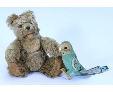 A Steiff ‘Zotty’ Teddy bear, German 1950s, the tan mohair bear with orange glass eyes, stitched nose and felt lined mouth, bu