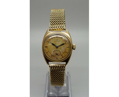 A gentleman's 9ct gold cased Omega wristwatch, serial number 8794995 with a 9ct gold bracelet strap, the Dennison case hallma