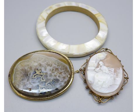A cameo in a plated mount, an agate brooch in plated frame and a mother of pearl bangle 