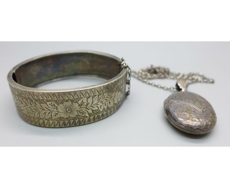 A silver locket and chain and a Victorian silver bangle 
