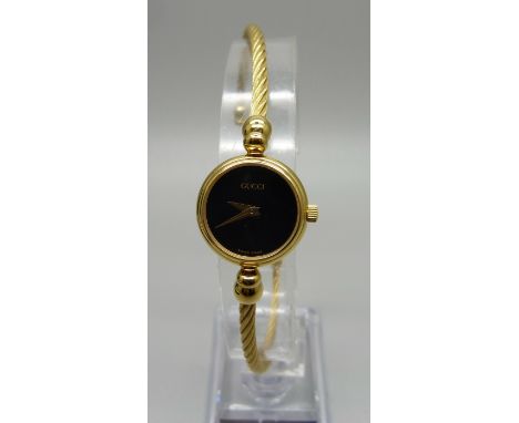 A lady's Gucci dress wristwatch with rope twist bangle, with box and papers 