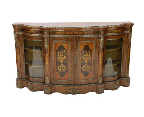 A Victorian marquetry inlaid walnut serpentine credenza, with ormolu mounts and floral marquetry panels, very similar but not