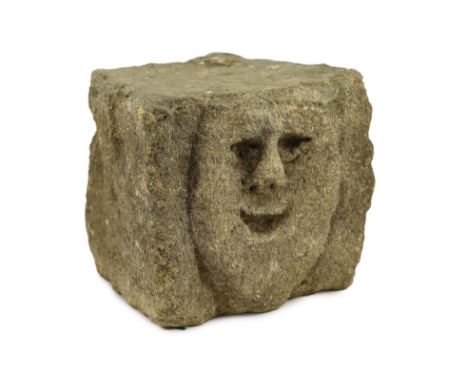 A rare Anglo-Saxon limestone mask corbel, 10th/11th century, the smiling face carved in bas-relief to a cube-shaped block of 