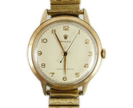 A gentleman's early 1950's 9ct gold Rolex Shock-Resisting manual wind wrist watch, on associated flexible bracelet, with Arab