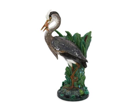 A Minton majolica life-size ‘heron’ stickstand, initialled J.H. for the modeller John Henk, c.1905, impressed marks and model