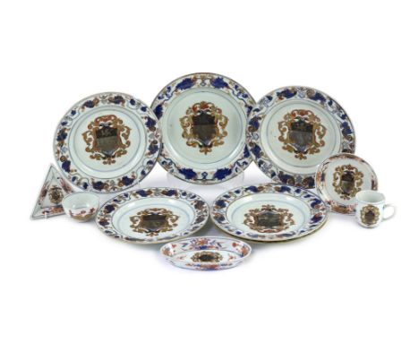 A Chinese export armorial part dinner and tea service, Kangxi period, c.1720, each piece painted in Imari palette with the ar