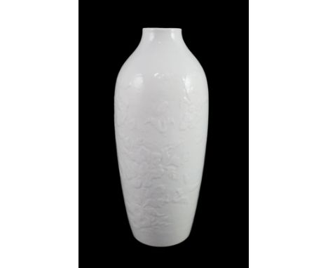 A Chinese moulded white glazed vase, Qianlong period, relief moulded with peonies and rockwork, 18.3cm high, glaze blemish**C