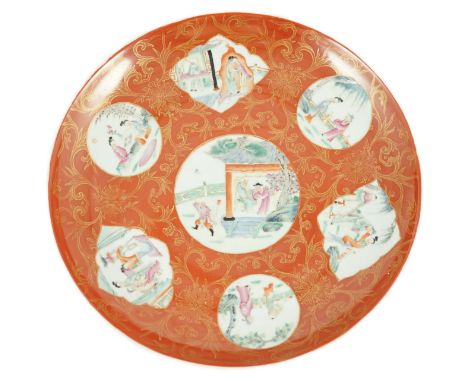 A Chinese coral ground dish, Qianlong seal mark but Republic period, painted in famille rose fencai enamels with scenes from 