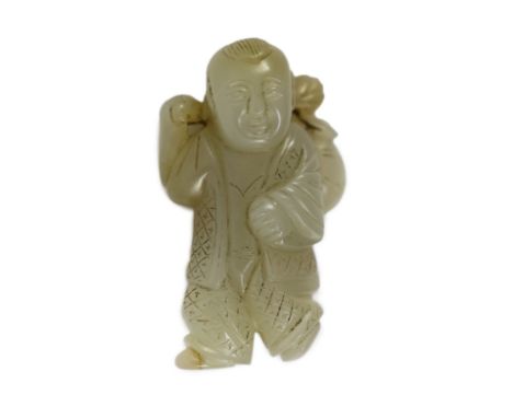 A Chinese pale celadon jade figure of a boy, 19th century, standing and holding a lotus sprig in his right hand, the stone wi