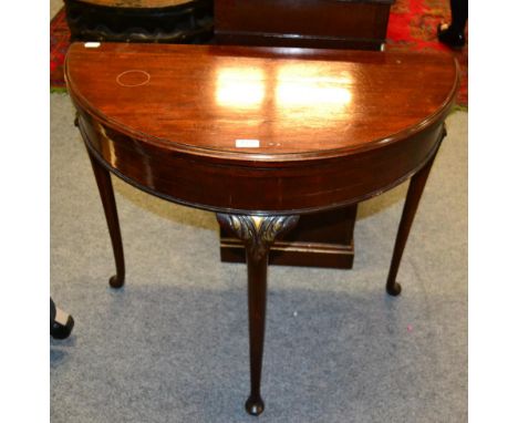 A mahogany D-shaped fold over card table .  87.5cm wide by 85cm high by 42cm deep. Tops with staining and surfaces are slight