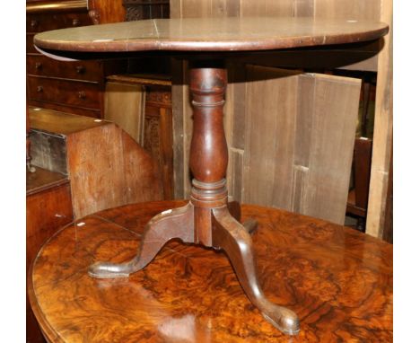 An oak tilt top tripod table 