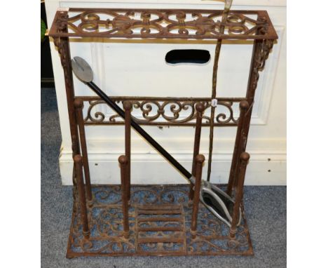 A metal combination stick stand and boot rack