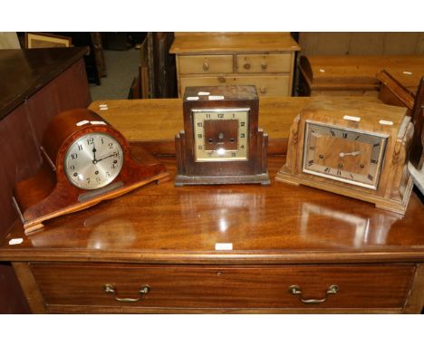 An Art Deco oak cased mantel clock; a similar walnut cased example; and a burr walnut cased striking mantel clock with presen
