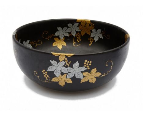 A Japanese black glazed porcelain bowldecorated in frosted gold and silver trailing fruiting vines, signeddiameter 21 cmCondi