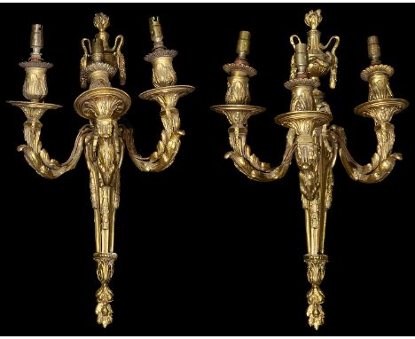 A pair of 19th century French Louis XVI style ormolu three light wall appliqueseach having a tapering backplate surmounted by