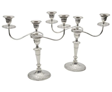 A pair of George V silver neo-classical design three light candelabra Sheffield, 1924 by Hawksworth, Eyre &amp; Co.of oval fl