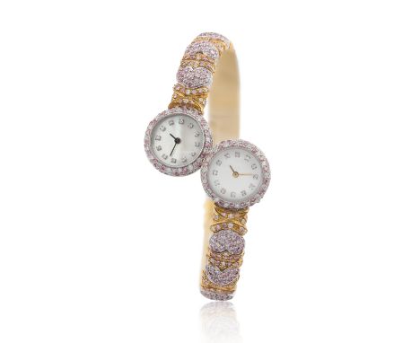 A  two colour gold, diamond and pink diamond duo-dial sprung bangle watch  Circa 1990 Each watch with quartz movements set to