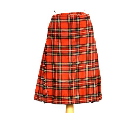 A vintage ladies tartan kilt, with label for Jespers The Border House Carlisle, three buckle fastening and leather straps 