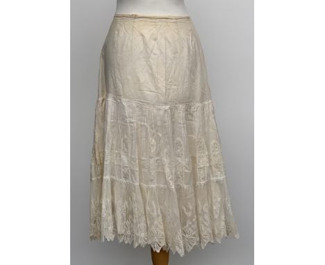 A 1920s white cotton underskirt with tie waist and lace detail; together with a further underskirt with pink ribbon detail, 6