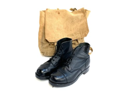 A pair of size 9 black leather army boots with metal heel and toe plates with studs; in canvas satchel 