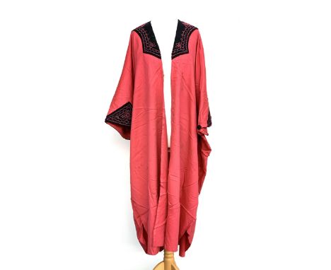 A vintage pink gown with black sleeve and collar with embroidered detail 