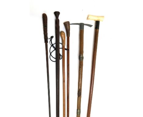 An early 20th century bone handled walking cane with silver collar, together with an Alpine stick marked Merloos; several oth