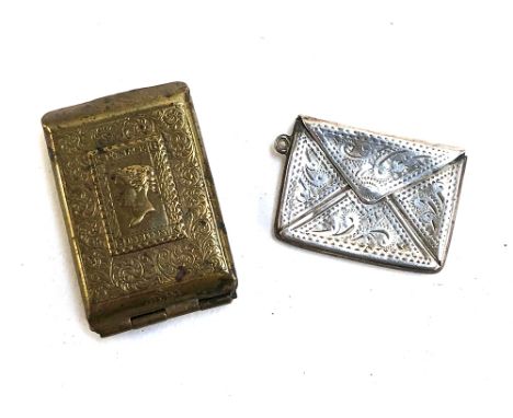 A small silver envelope stamp case; together with a Victorian penny stamp brass needle case (2) 