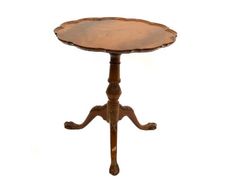 A George III style tripod table, shaped tip top raised on a turned and carved column and tripod cabriole legs with ball and c
