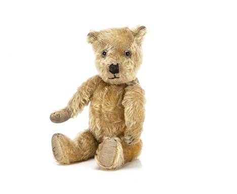 A miniature home made early 20th century Edith Moody design teddy bear, with clear and black glass eyes, black stitched nose 