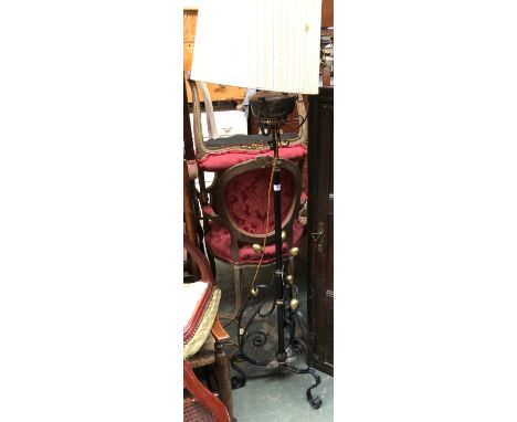 A high quality brass and copper adjustable standard lamp, converted for electric use, on triform scrolling base terminating w