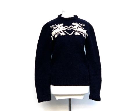 A vintage navy ski jumper with zip back, crew neck and reindeer pattern, approx. size 8 
