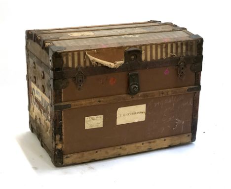 A 19th/early 20th century wood and canvas covered domed travel trunk, with lined interior, travel stickers, 71cm wide, 54cm h