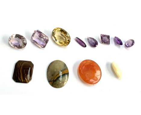 A collection of unmounted stones to include a white opal, 2.6x0.7cm; carved carnelian cameo; amethysts; citrine etc 