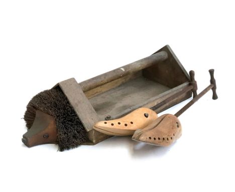 A pair of vintage shoe trees; together with a hedgehog boot scraper 