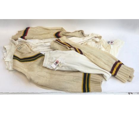 A mixed lot of cricket whites to include tops and trousers, some new, sleeveless club jumpers, etc (in a long vintage suitcas