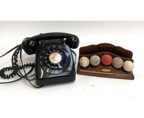 A vintage rotary telephone with label for Bristol; together with a model of 'Early Golf Balls' (2) 