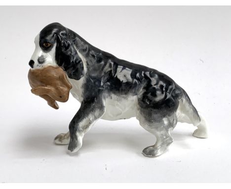 A Royal Worcester porcelain figure of a spaniel holding a rabbit, model number 3310, 9cmH 