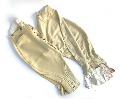 A pair of mens cavalry twill hunting breeches, brass buttons by Thomas &amp; Sons, 32 Brook Street, with cutaway pockets and 