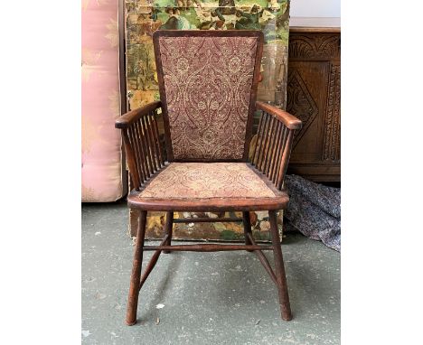 An arts and crafts Liberty style open armchair, the arms with stick supports, on splayed tapering legs and peripheral stretch