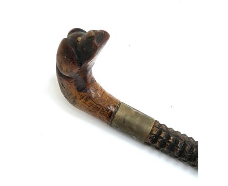 Folk art interest: a naively carved walking stick with dog mask handle, 83cmL 