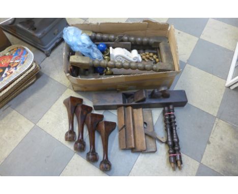 A box of bobbin turned and Queen Anne style furniture legs, brass door knobs and other handles and a large antique plane