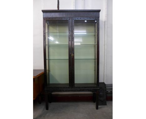 A Victorian carved mahogany shop display cabinet